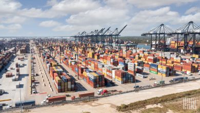 Cargo containers stacked at a busy U.S. port terminal as Section 301 forced labor tariffs of 10% to 12.5% take effect on imports from 60 economies
