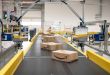An automated conveyor system moves packages through an Amazon facility.