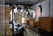 A robot loads boxes in truck compartment.
