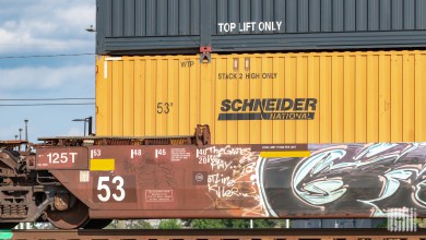 a Schneider intermodal container on a well car