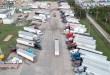 Aerial view of a crowded truck terminal packed with semi-trucks and trailers as truck capacity tightens and shipper freight costs rise